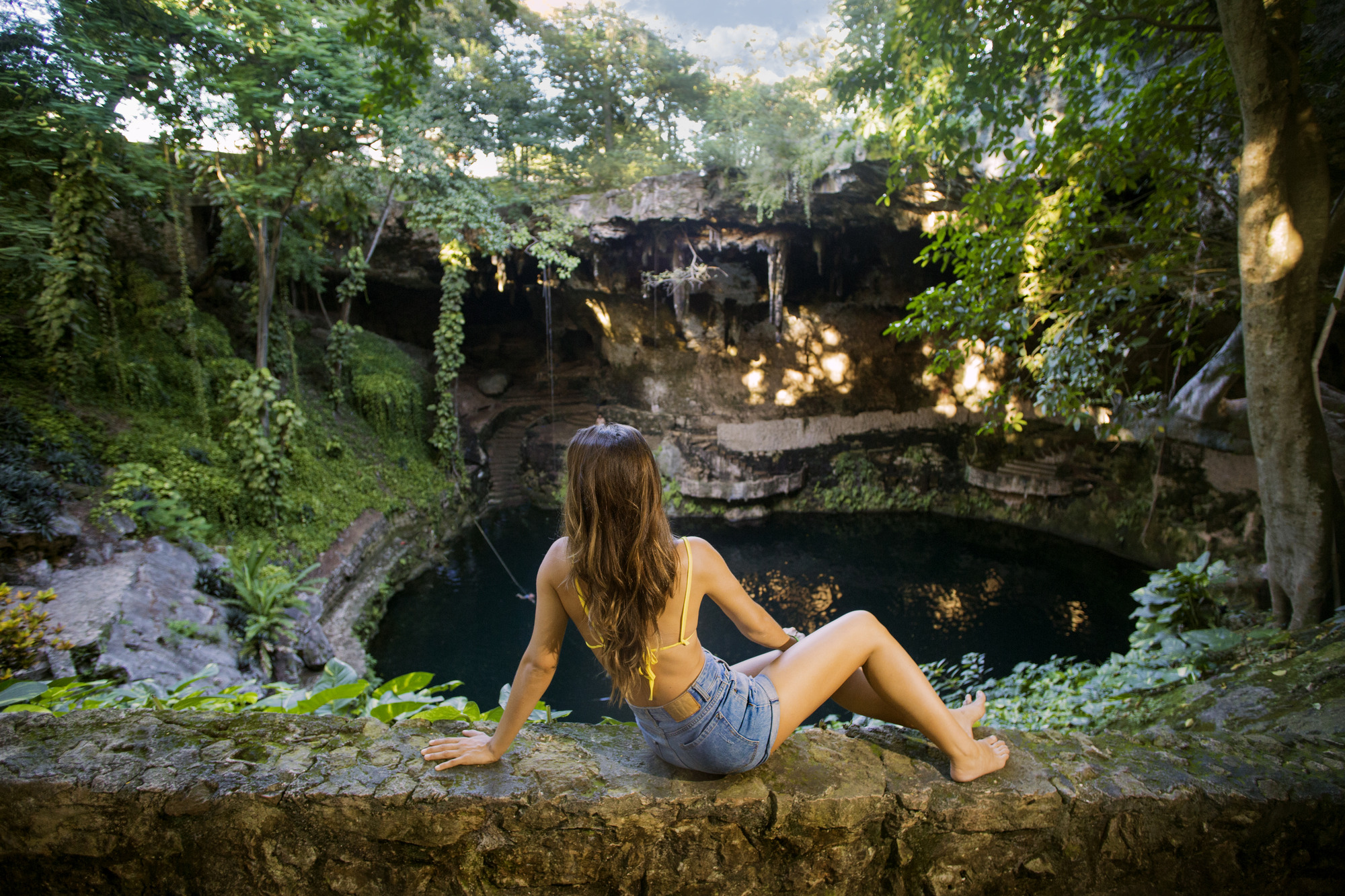 Young lady enjoying the cenote view during the Chichinitza tour