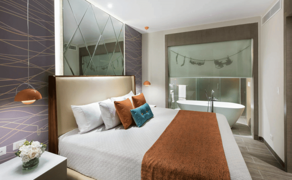Modern king bedroom with freestanding bathtub – Nickelodeon Hotel & Resort Punta Cana