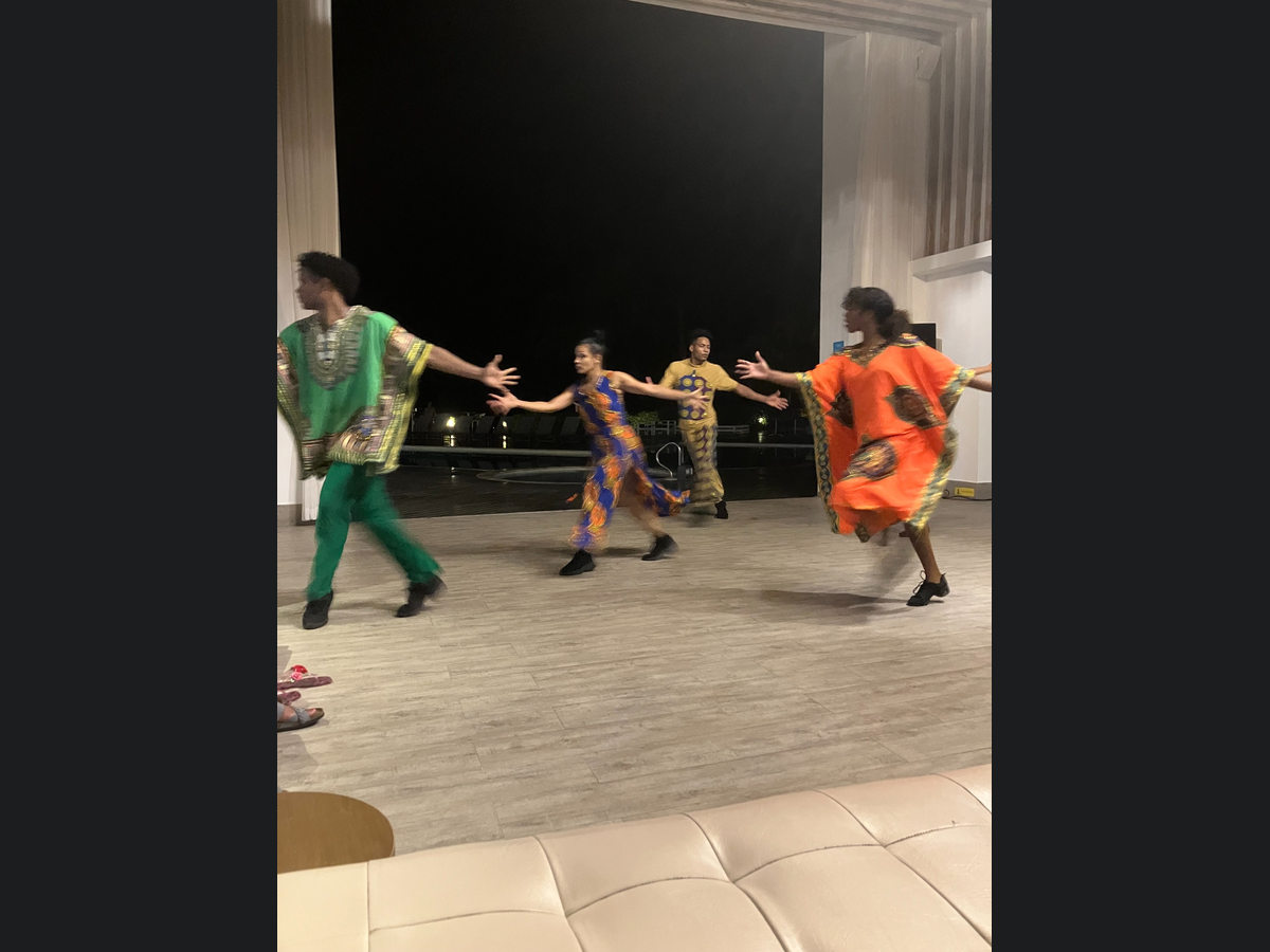 Performers in colorful clothing during an evening cultural dance show at Azul Beach Resort Negril
