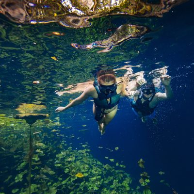 Couple Snorkling at the Xenotes Tour by Xcaret